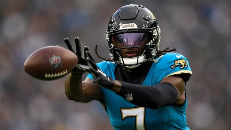 Jacksonville Jaguars wide receiver Brian Thomas Jr. in full stride on a deep vertical route, extending for a pass during a high-energy 2026 NFL play in his teal home uniform.
