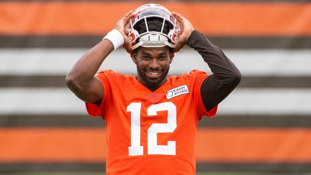 Deshaun Watson and Shedeur Sanders in Cleveland Browns uniforms staring down the competition during 2026 training camp preparations.