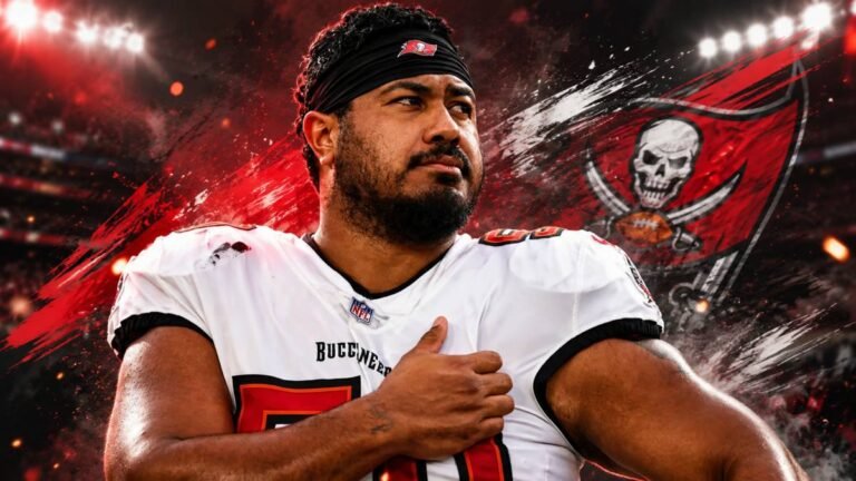 Tampa Bay Buccaneers defensive tackle Vita Vea in full red and pewter uniform, engaged low at the line of scrimmage during a bright Florida practice or game, showing his strength and intensity as a nose tackle.