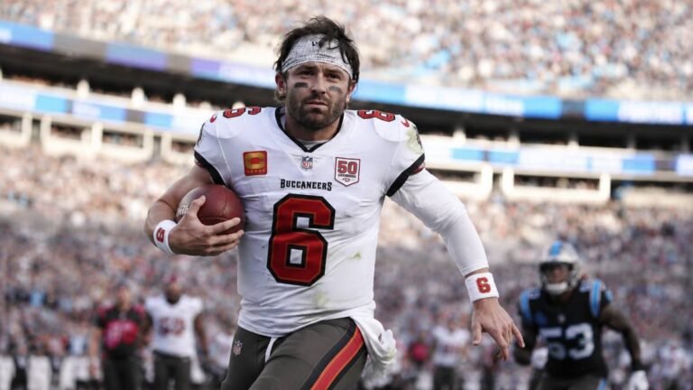 Baker Mayfield in Tampa Bay Buccaneers uniform speaking to media during 2026 training camp after failed contract extension talks.