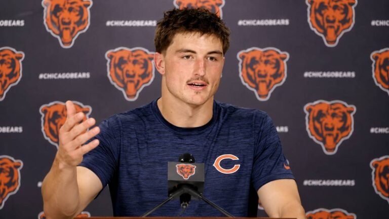 Chicago Bears tight end Colston Loveland in navy practice jersey number 84 catching a football during 2026 training camp.