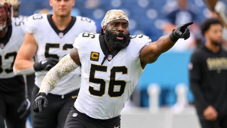 New York Jets linebacker Demario Davis in green and white uniform during 2026 OTAs, intensely focused while training with teammates blurred in the background at the team facility, embodying veteran leadership and culture building under Aaron Glenn.