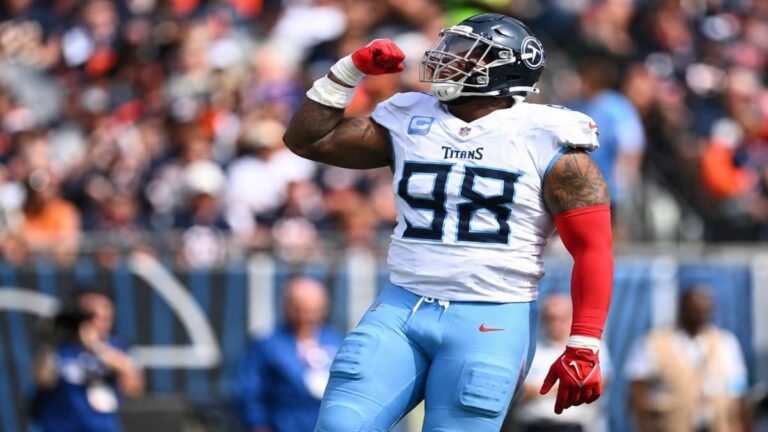 Tennessee Titans defensive tackle Jeffery Simmons #98 penetrating the offensive line and splitting a double team in a 2026 NFL game under new head coach Robert Saleh.