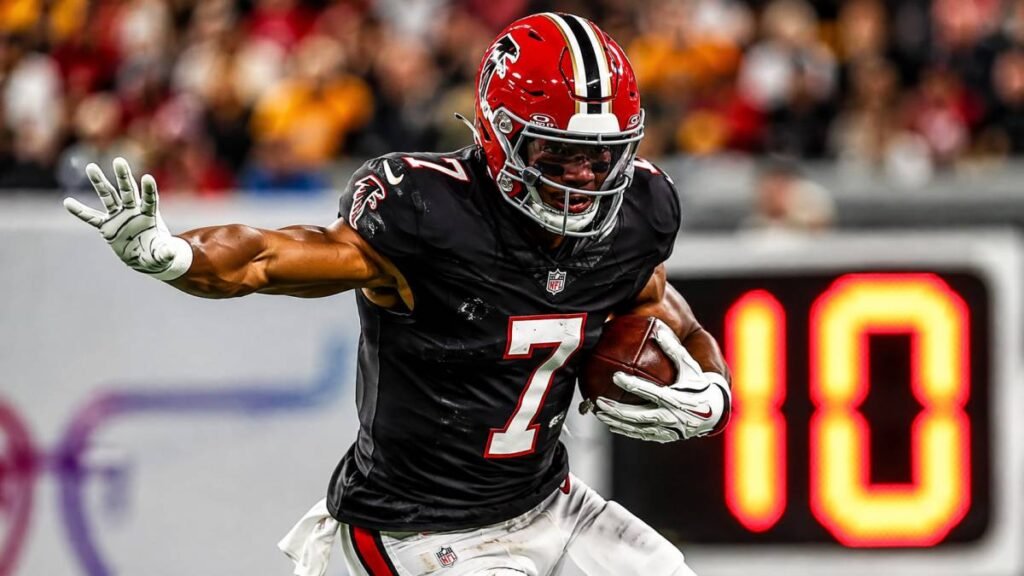 Atlanta Falcons running back Bijan Robinson in white No. 7 jersey carrying the football during a 2025 game.